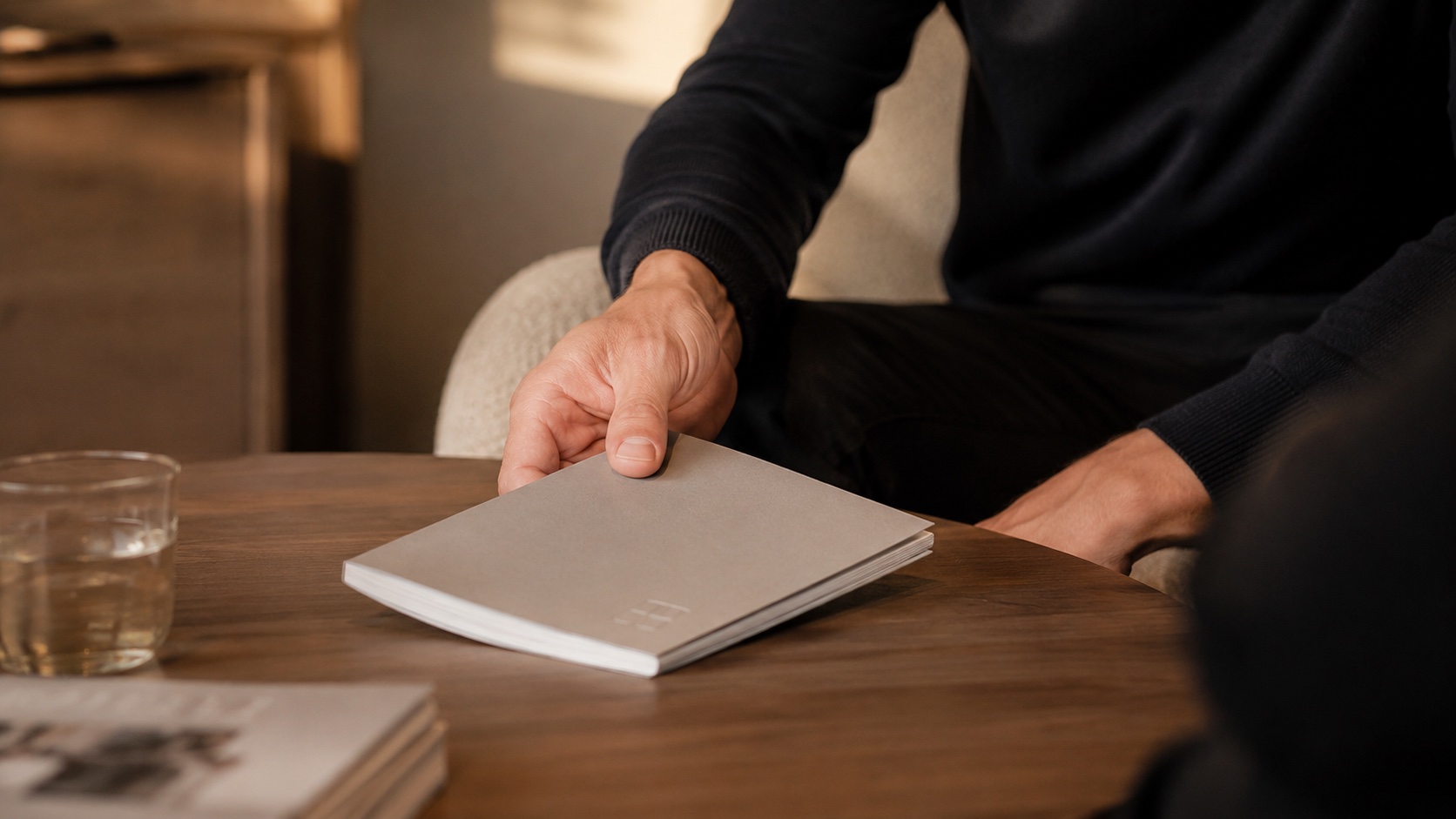 Hand presenting a brochure during an intro meeting